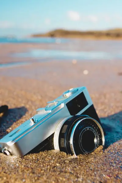 Aparat fotograficzny na plaży – symbol uchwyconych wspomnień i pamięc Co daje czytanie książek? Czytanie jako tarcza ochronna przed Alzheimerem. Regularne czytanie zmniejsza ryzyko tej choroby i pozwala zachowac wspomnienia jak aparat fotograficzny.