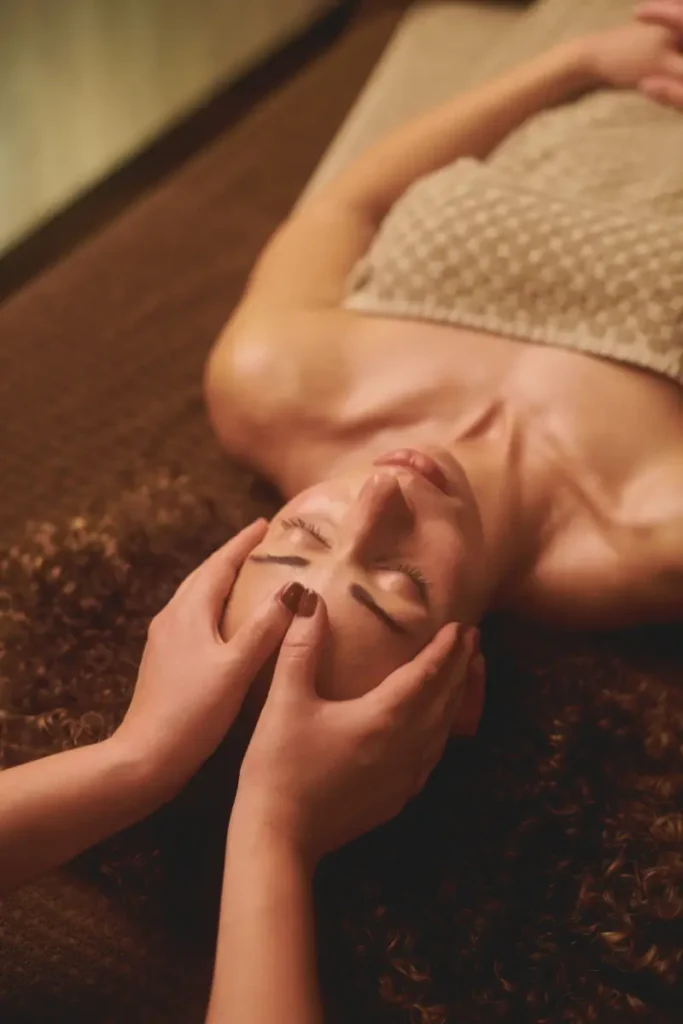 Kobieta wykonująca masaż Kobido w domowym zaciszu